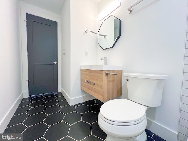 bathroom with tile patterned floors, toilet, and vanity