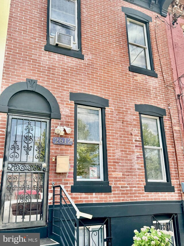 doorway to property featuring cooling unit