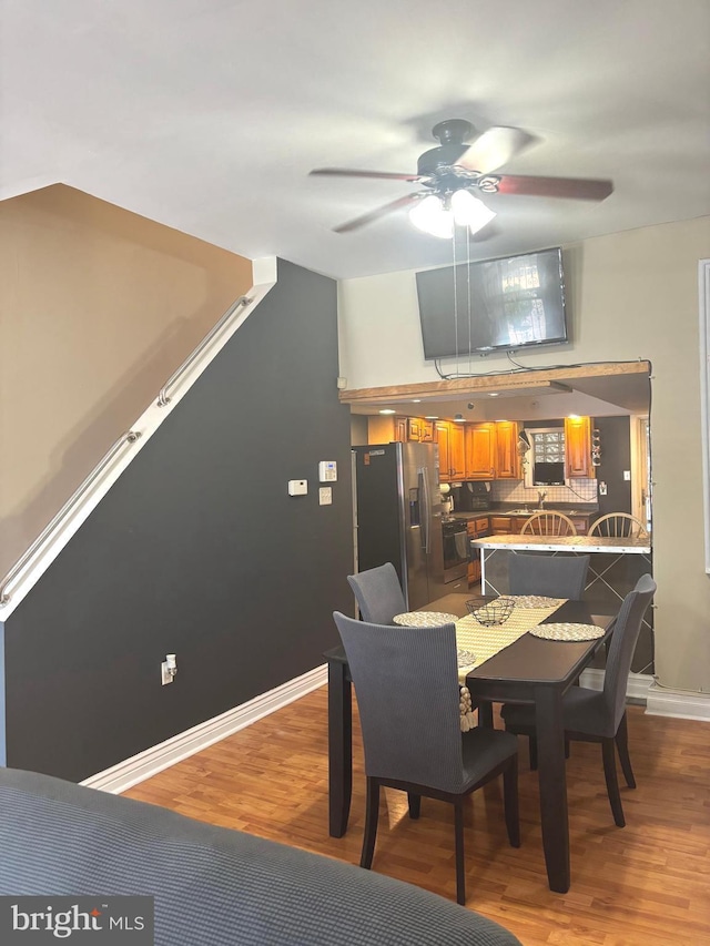 dining room with ceiling fan and light hardwood / wood-style flooring