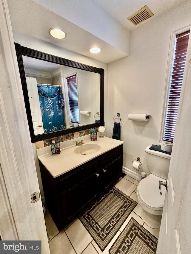 bathroom featuring vanity, toilet, and tile patterned flooring