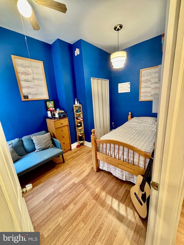 bedroom with hardwood / wood-style flooring and ceiling fan