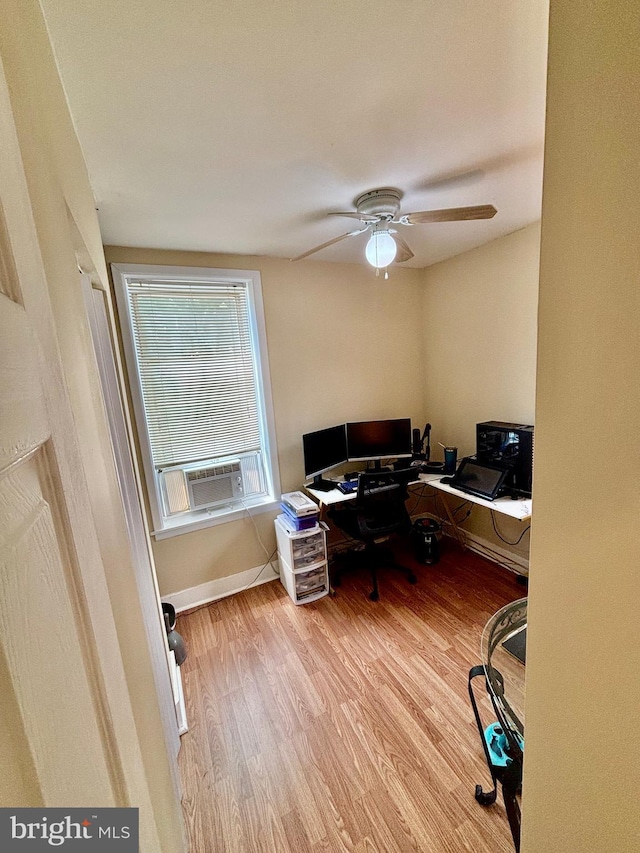 home office with ceiling fan, cooling unit, and light hardwood / wood-style floors