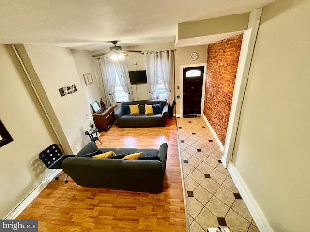 living room featuring wood-type flooring and ceiling fan