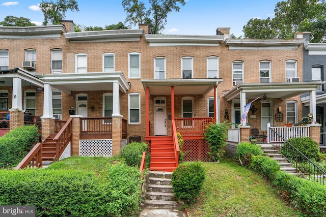 townhome / multi-family property featuring cooling unit and a porch