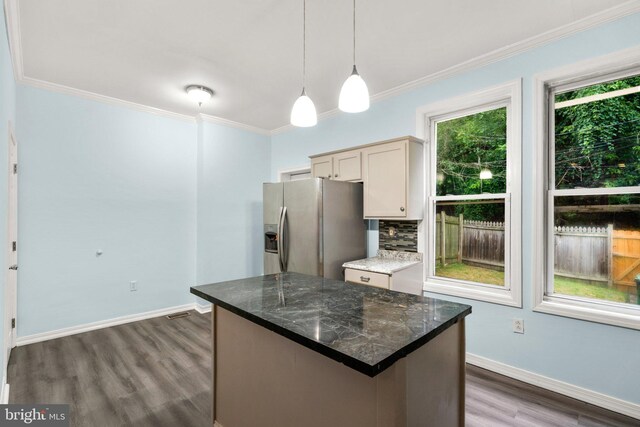 kitchen featuring stainless steel fridge with ice dispenser, dark hardwood / wood-style floors, ornamental molding, and hanging light fixtures