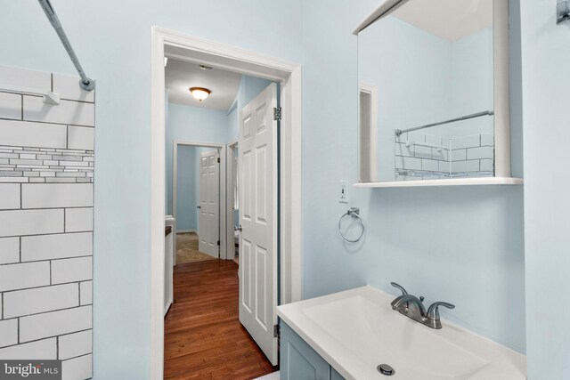 bathroom featuring vanity, wood-type flooring, and a shower