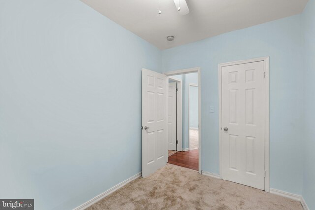 unfurnished bedroom featuring light carpet