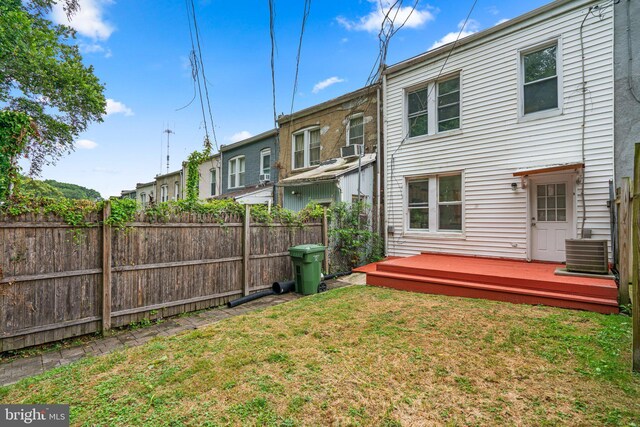 back of house with a wooden deck, a yard, and cooling unit