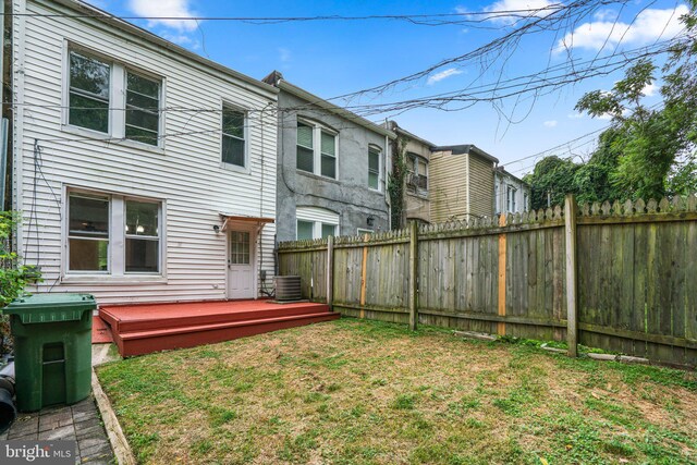 view of yard with a wooden deck and central AC unit