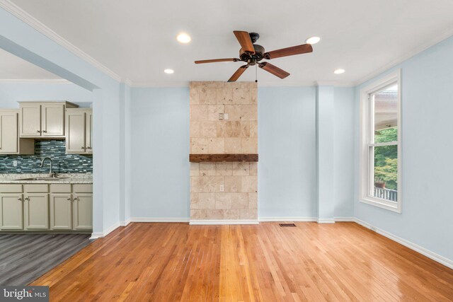 interior space featuring crown molding, sink, ceiling fan, and light wood-type flooring