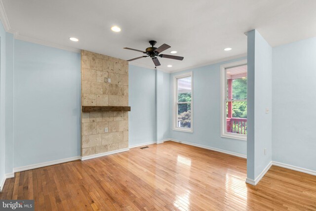 unfurnished living room featuring crown molding, ceiling fan, and light hardwood / wood-style floors