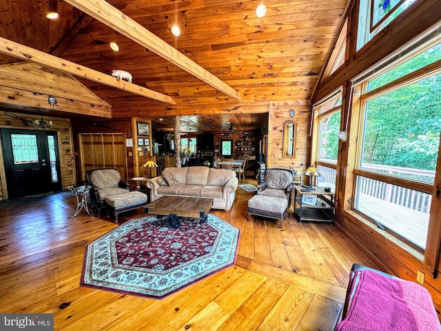 living room with wood walls, wooden ceiling, and wood-type flooring