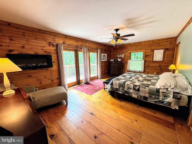 bedroom with hardwood / wood-style flooring, access to exterior, and ceiling fan