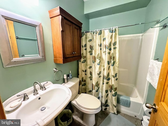 full bathroom with sink, shower / bath combo with shower curtain, and toilet