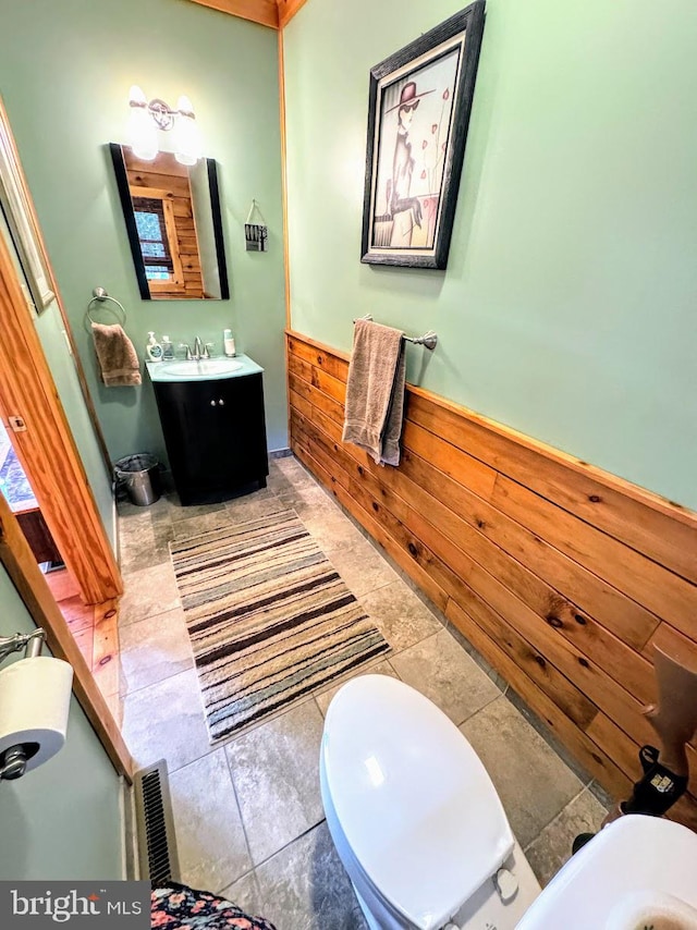 bathroom featuring vanity, tile patterned floors, and toilet