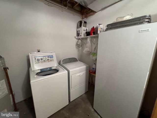 laundry area with water heater and washing machine and clothes dryer