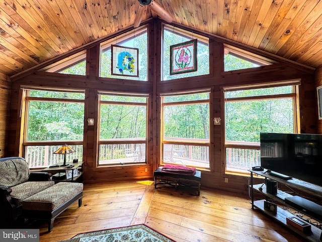 living room with wood ceiling, lofted ceiling, and light hardwood / wood-style floors