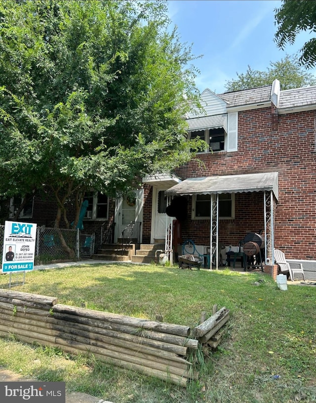 rear view of house with a yard