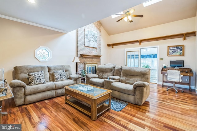 living room featuring a brick fireplace, ceiling fan, crown molding, high vaulted ceiling, and hardwood / wood-style floors