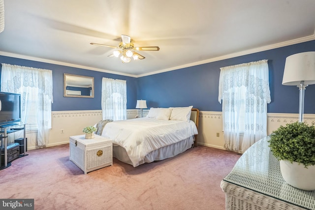 carpeted bedroom featuring multiple windows, ceiling fan, and ornamental molding