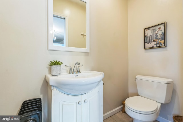 bathroom with tile patterned floors, vanity, and toilet