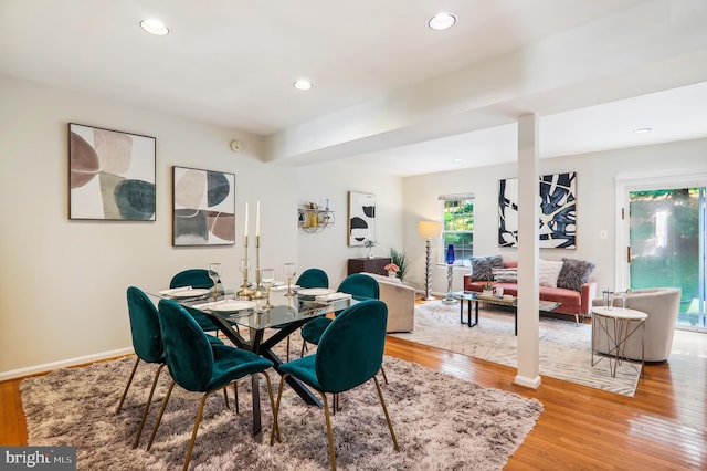 dining room with baseboards, wood finished floors, and recessed lighting