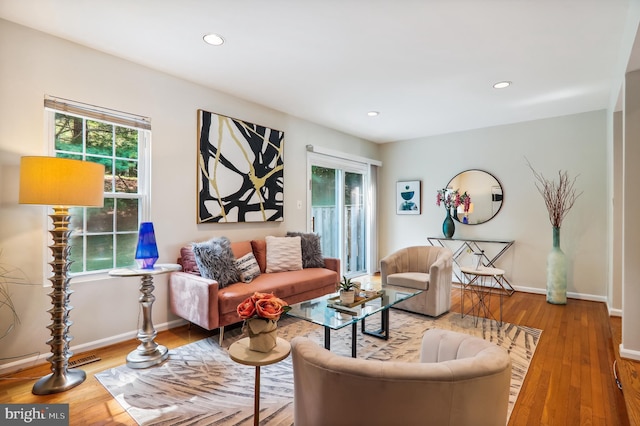 living area with recessed lighting, baseboards, and wood finished floors