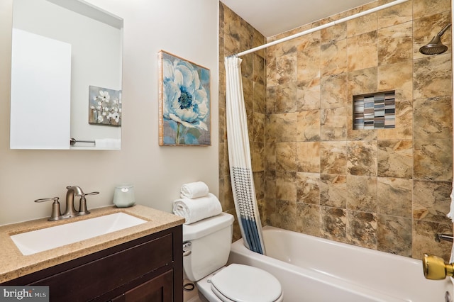 bathroom featuring toilet, shower / bath combo with shower curtain, and vanity