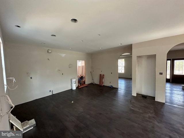 unfurnished room with dark wood-type flooring