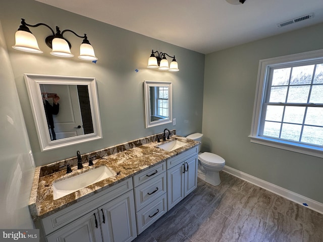 715 Parishville Rd, Gore, VA 22637 - bathroom with toilet, double vanity, a sink, and visible vents