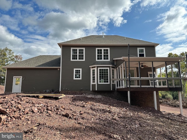 rear view of house featuring a wooden deck, ceiling fan, and a sunroom