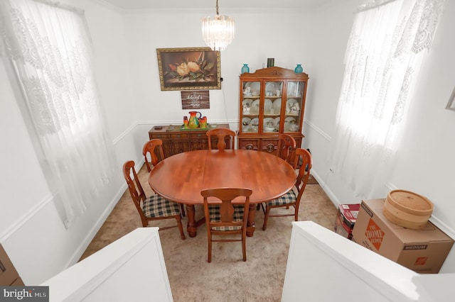 dining area featuring an inviting chandelier and ornamental molding