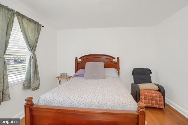 bedroom with wood-type flooring