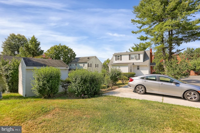 view of front of property with a front lawn and a storage unit