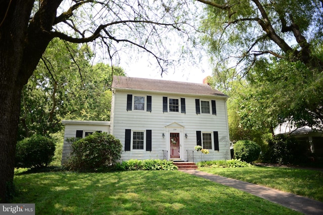 colonial-style house with a front lawn