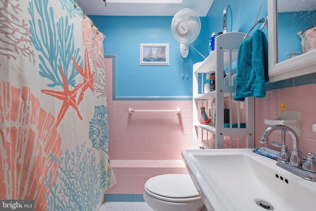 bathroom with sink, tile walls, tile patterned floors, and a shower with shower curtain