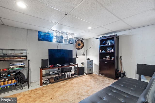 carpeted living room with a paneled ceiling