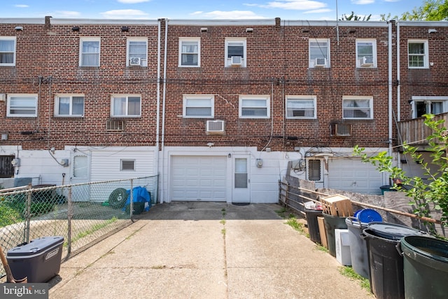 rear view of house featuring a garage