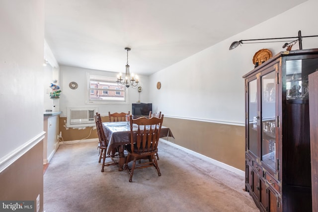 dining area with light carpet and an inviting chandelier