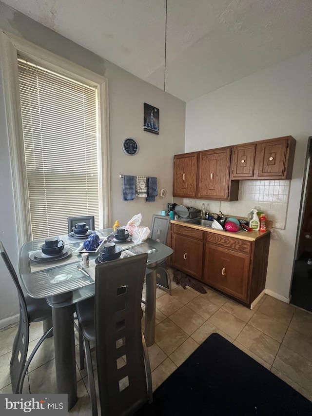 tiled dining area featuring sink