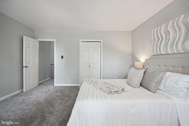 bedroom featuring a closet and dark colored carpet