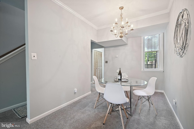 dining area featuring crown molding, carpet flooring, and an inviting chandelier