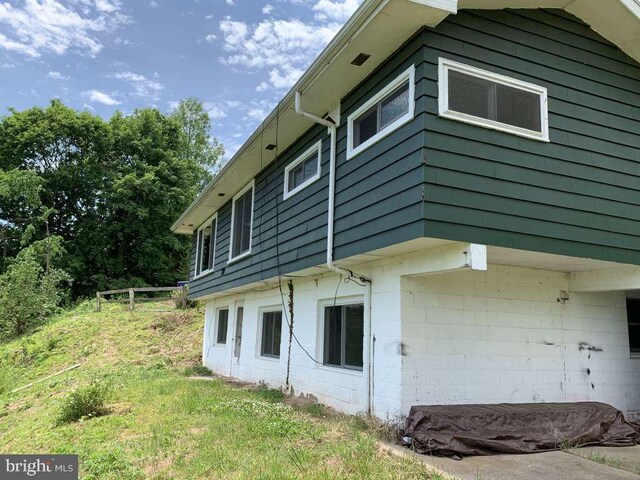 view of property exterior with a yard