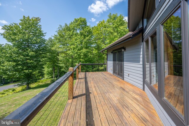 wooden terrace with a lawn