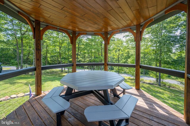 wooden deck featuring a yard