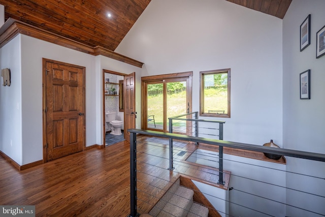 interior space with dark hardwood / wood-style flooring, high vaulted ceiling, and wooden ceiling