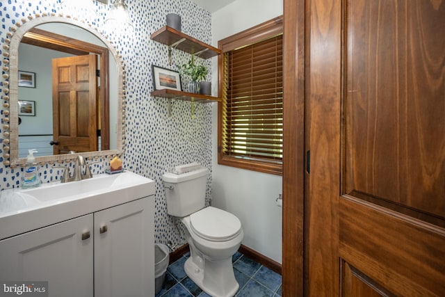 bathroom featuring vanity, tile patterned flooring, and toilet