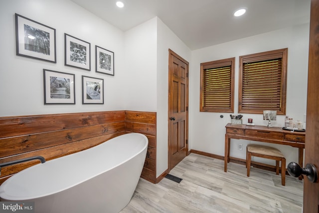 bathroom with a tub to relax in and vanity