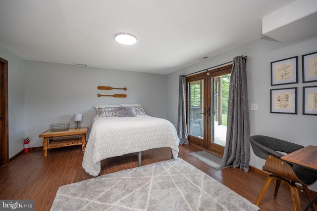 bedroom with access to exterior and hardwood / wood-style floors