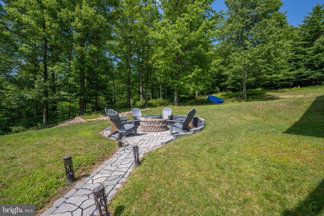 view of yard with a patio and an outdoor fire pit